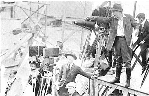 Photo of DeMille at work in silent film era